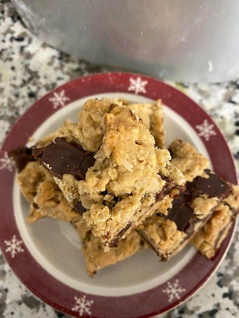 Stack of cookie bars on Christmas plate.