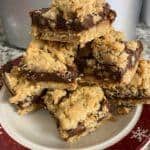 Bar cookies stacked on Christmas plate.