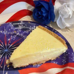 Lemon Cheesecake on a red, white, and blue plate.