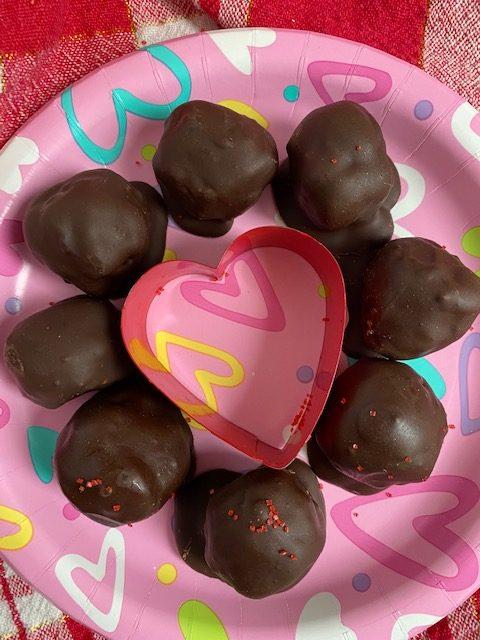 Mint Truffles on pink plate with heart in the middle.