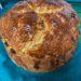 Round loaf of soda bread on green towel