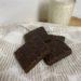 Chocolate Shortbread Cookies on white towel with glass of milk in background