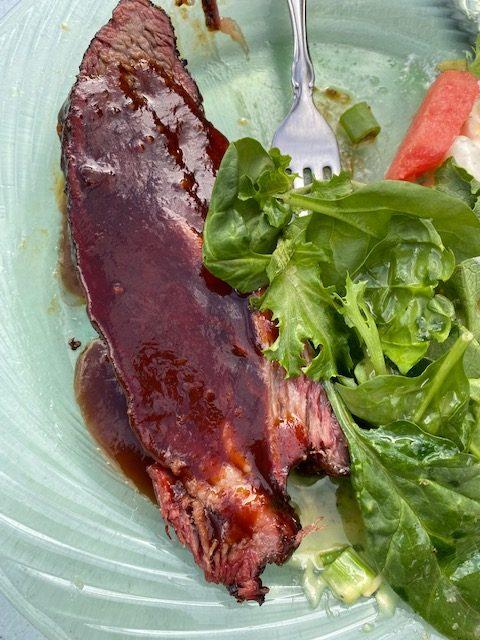 Brisket with barbecue sauce and salad on the side