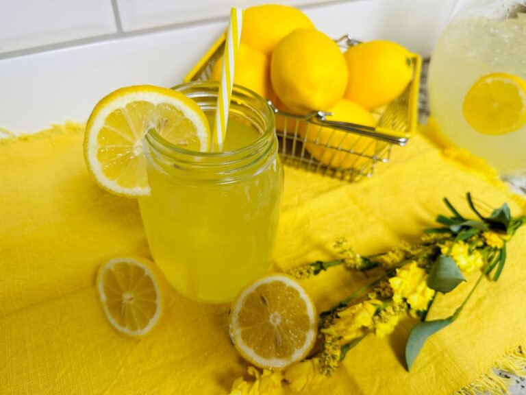 Glass of Lemonade on yellow placemat.