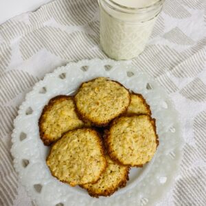 Lacy Oatmeal Cookies on white plate with glass of milk.