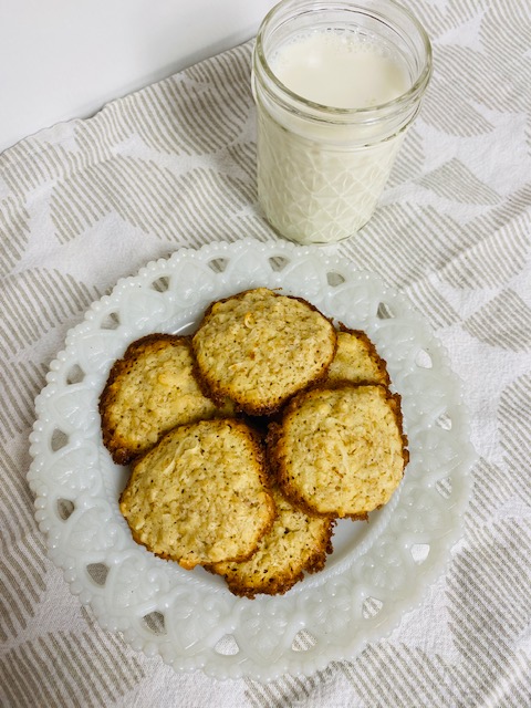 Lacy Oatmeal Cookies on white plate with glass of milk.