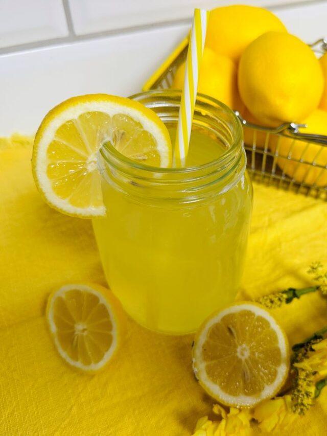 Glass of Lemonade on yellow placemat.