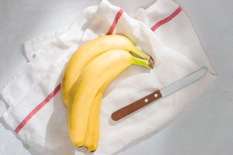 Fresh bananas on fabric background.