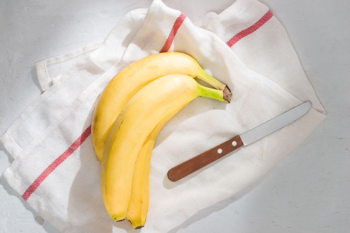 Fresh bananas on fabric background.