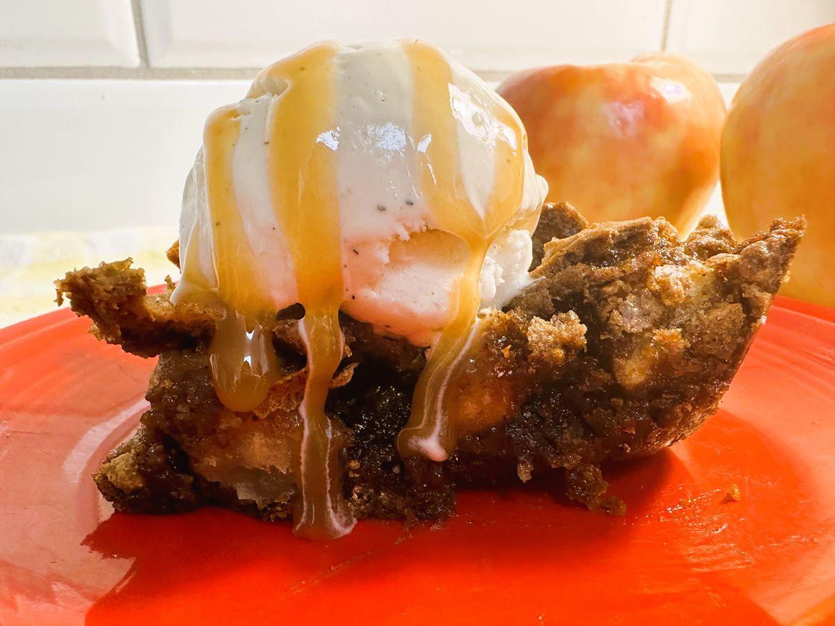 Close up of apple bar with vanilla ice cream and caramel drizzle on top.