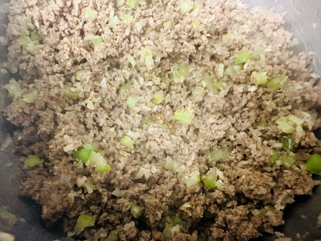 Cooked ground beef with vegetables.