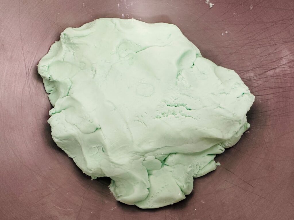 Green dough in silver bowl.