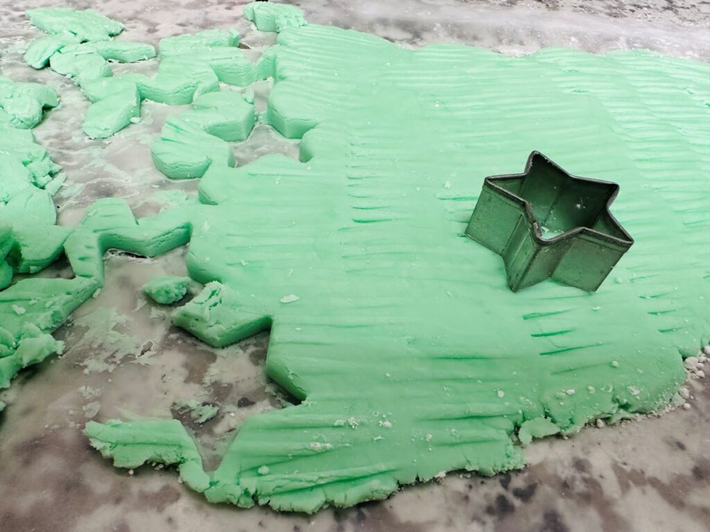 Star shapes cut out of rolled out green dough.