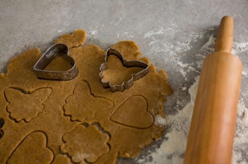 Rolled out cookie dough with heart and star cookie cutters on top.