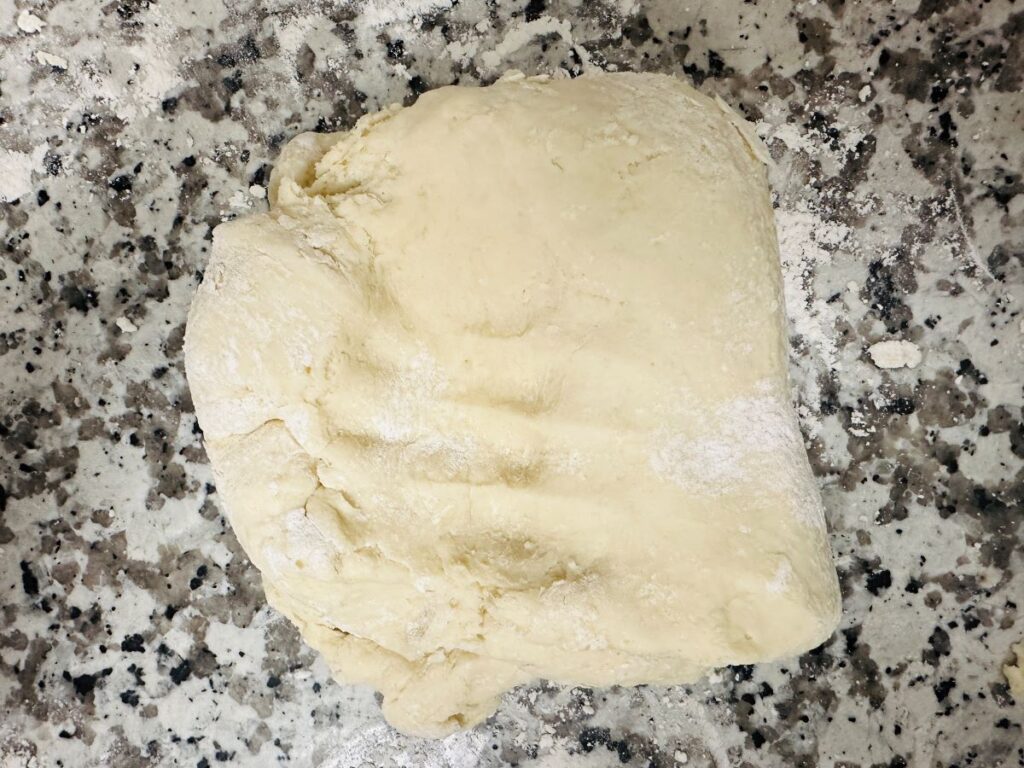 Ball of kneaded dough on counter.