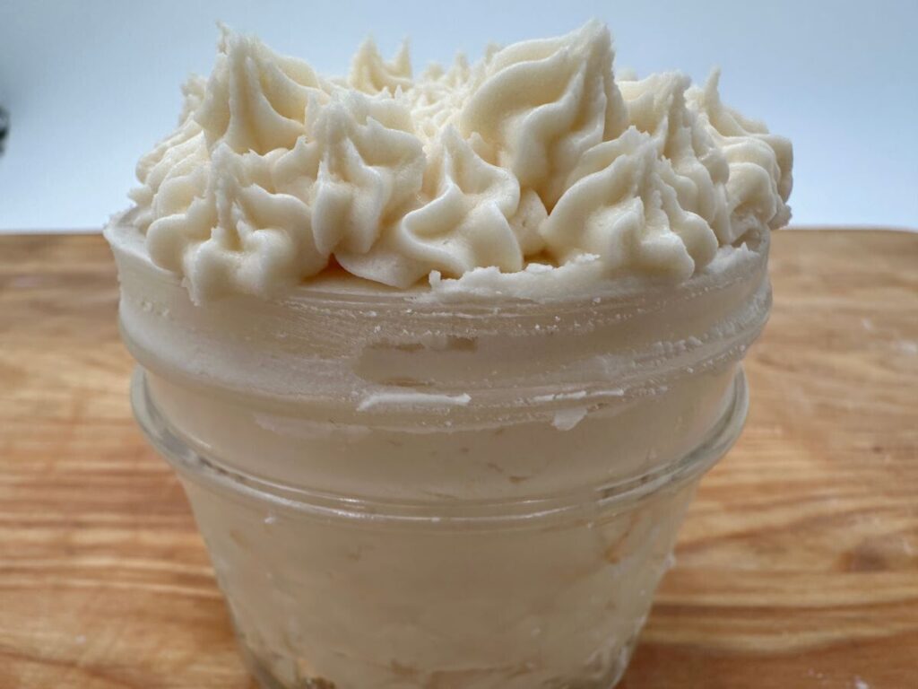 White frosting in clear glass jar.