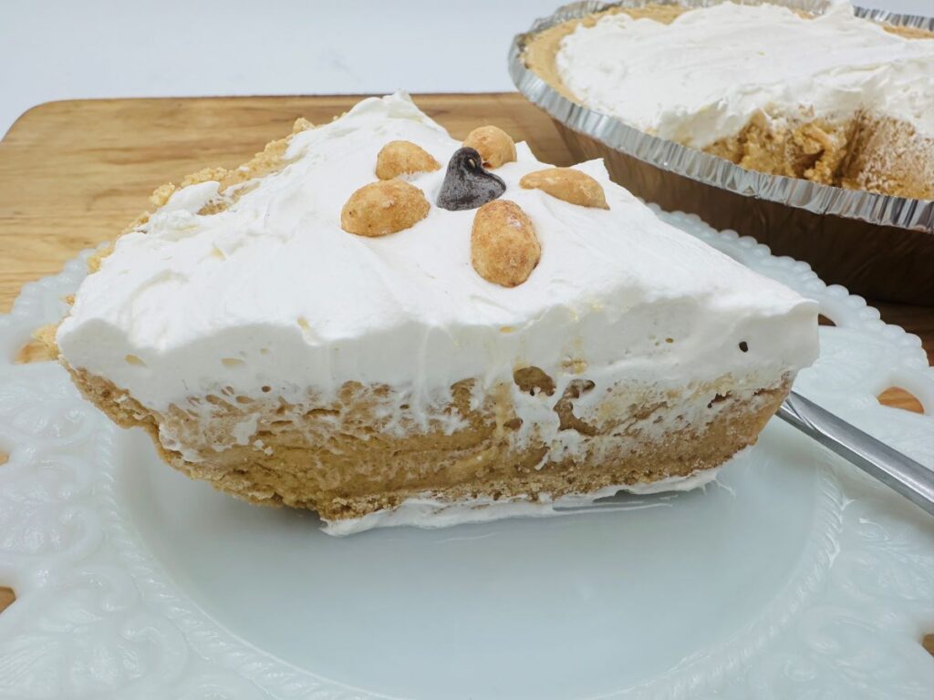Close up of peanut butter pie with pie in background.