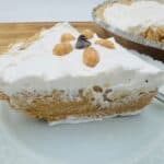 Close up of peanut butter pie with pie in background.