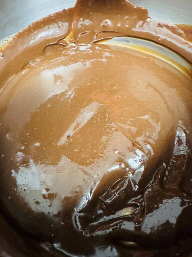 Melted chocolate in silver pot.