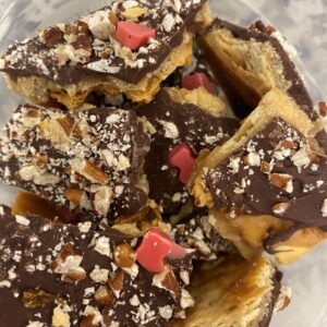 Pile of saltine toffee in clear bowl.