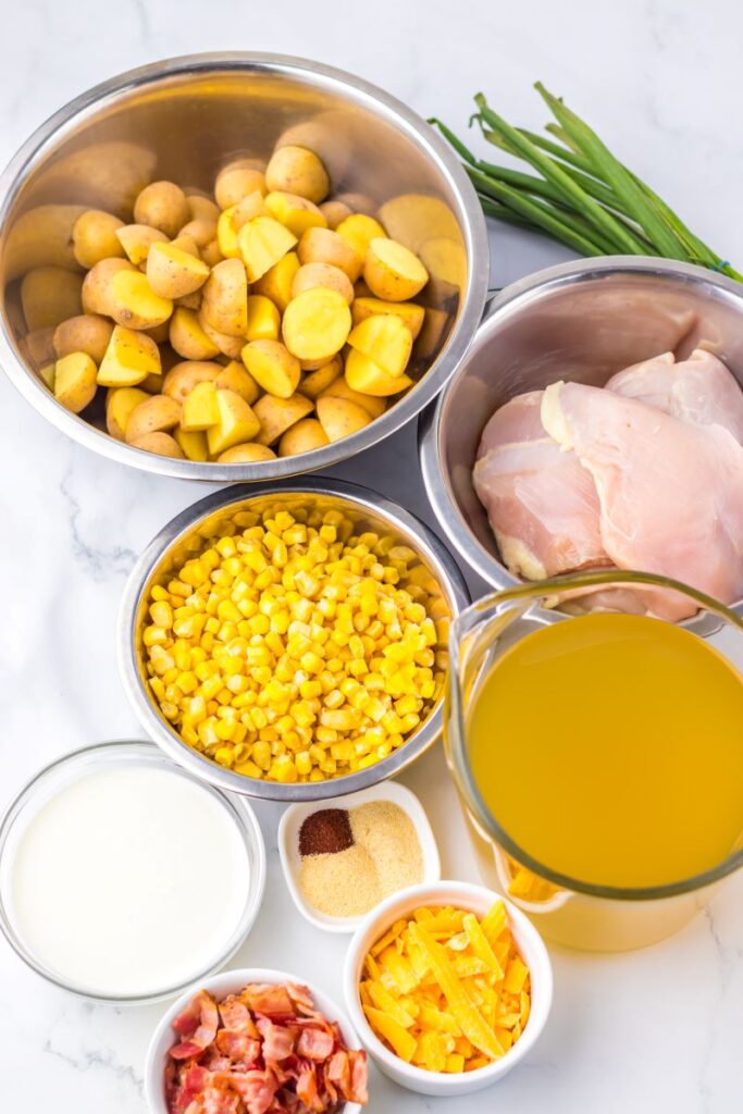 Ingredients for chicken corn chowder on marble board.