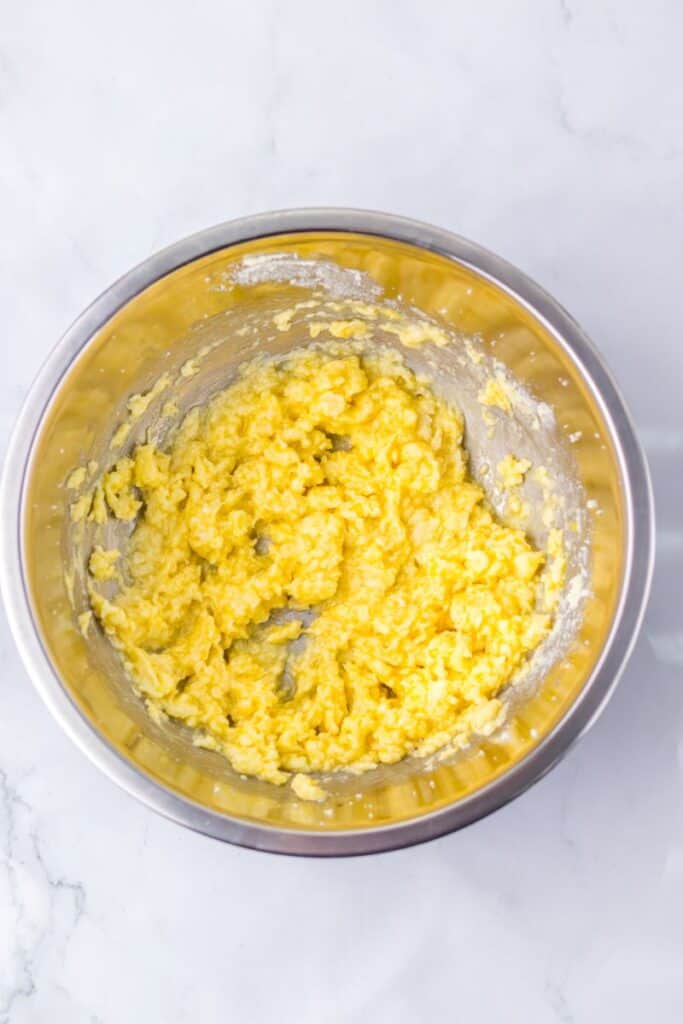 Yellow butter mixture in silver bowl.