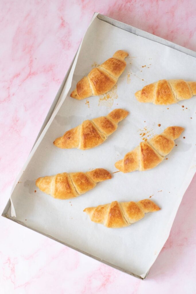 Top view of cookie sheet with 6 croissants.