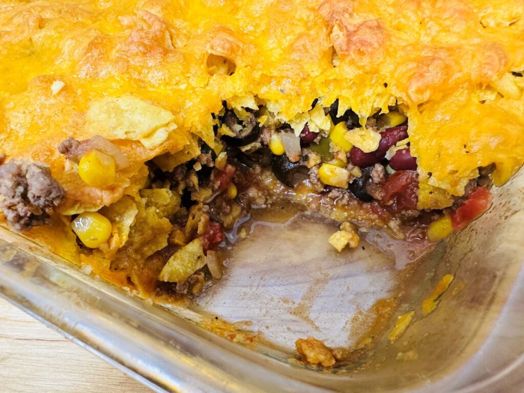 Top view of casserole with one serving missing.