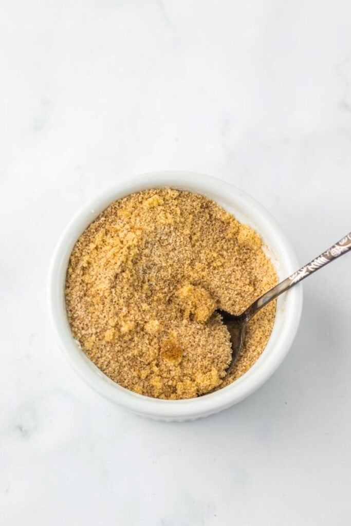 Crumbs in white bowl with spoon.