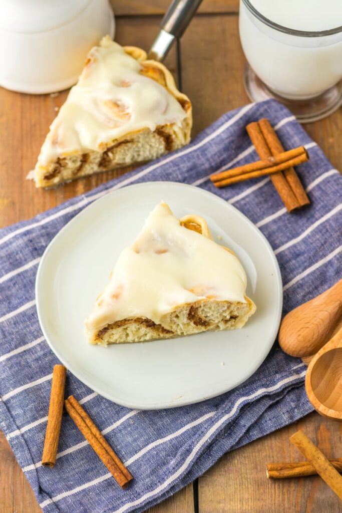 Top view of cinnamon roll pie on white plate.