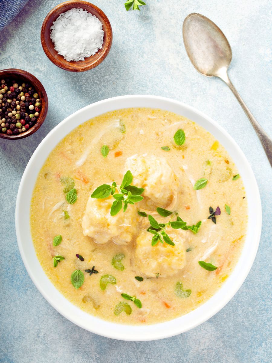Top view of tan-colored soup in white bowl.