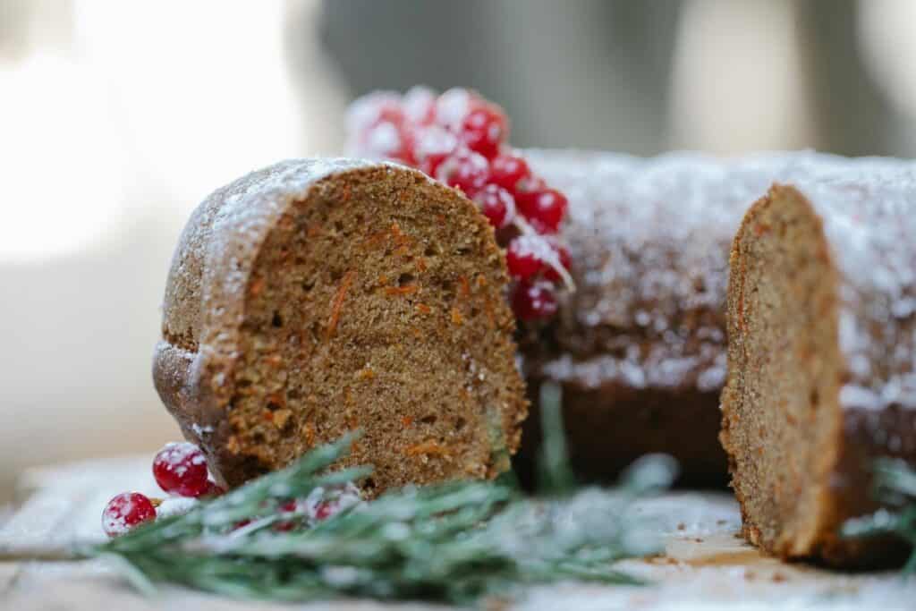 Close up of carrot bundt cake with slice missing.