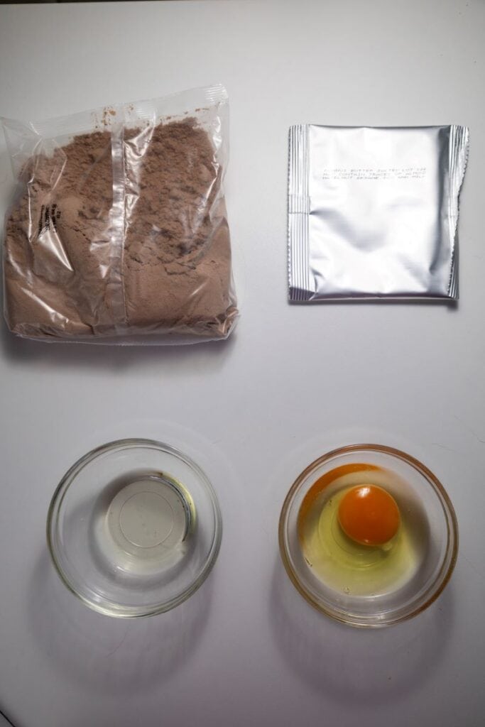 Ingredients for chocolate peanut butter brownies on white background.