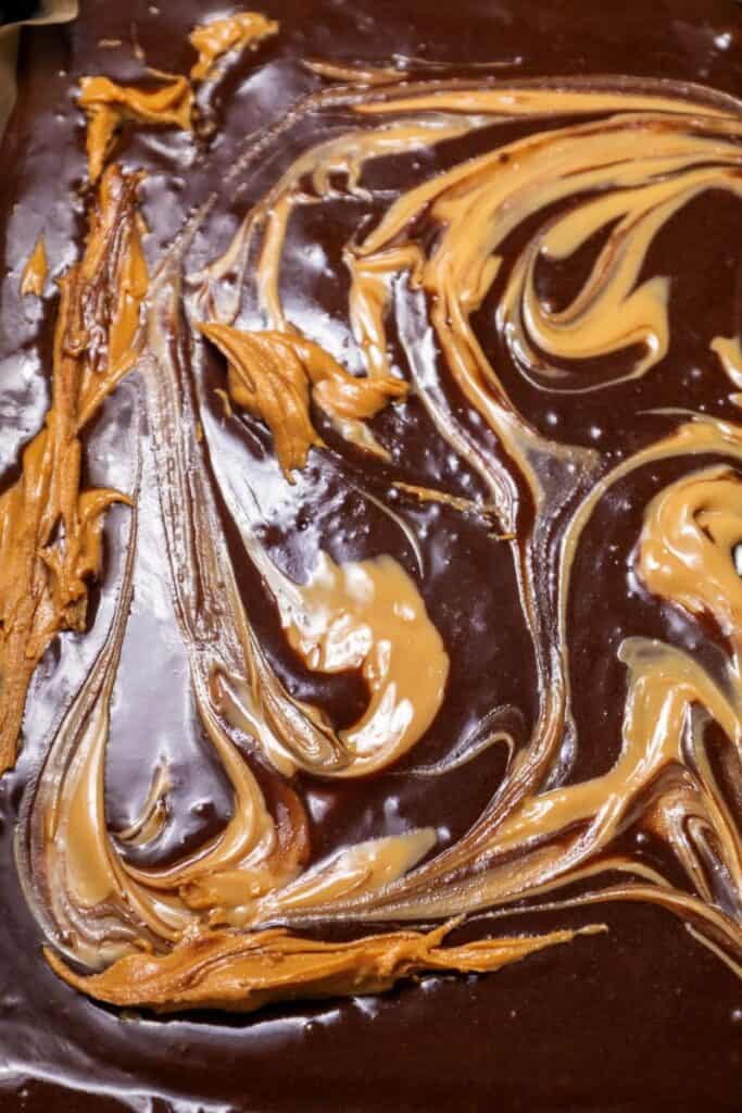 Brownie batter with peanut butter swirls.