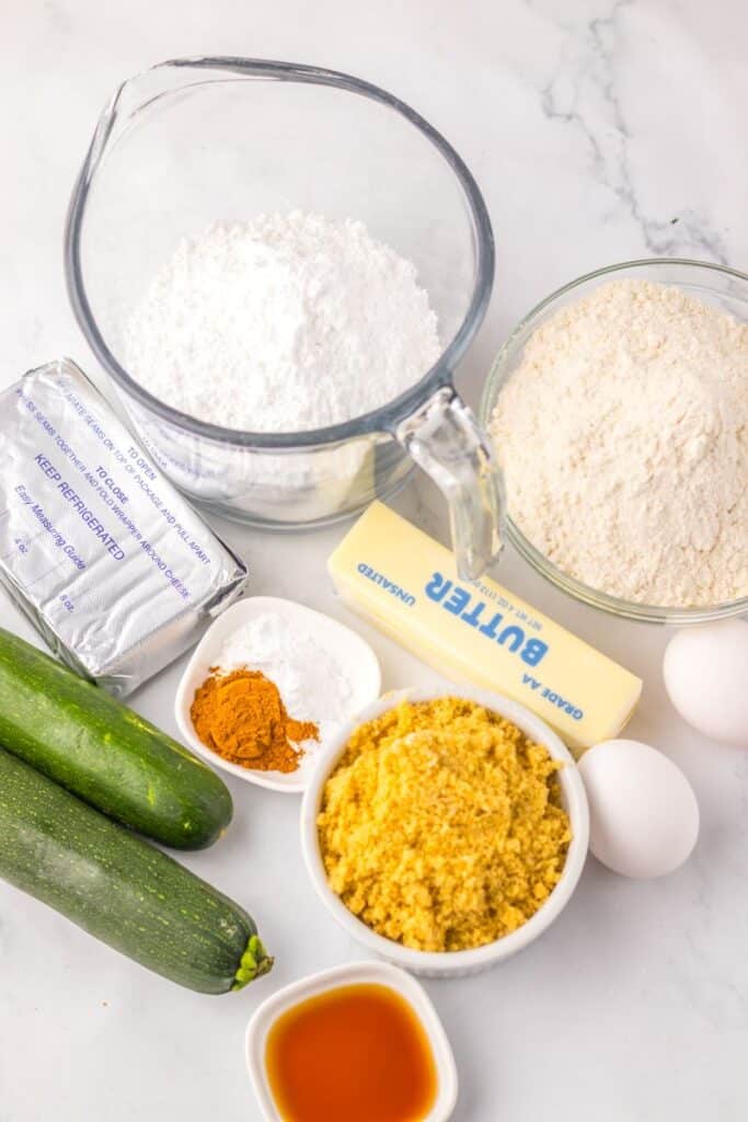 Ingredients for zucchini cake on white background.