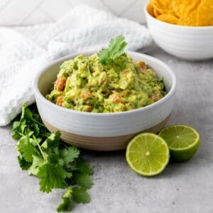 White bowl of green guacamole.