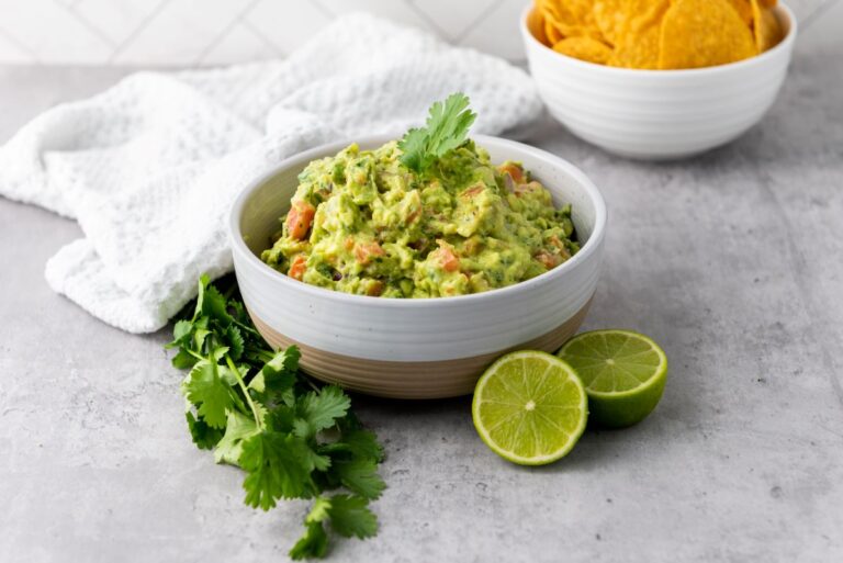 White bowl of green guacamole.