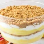 Close up of layered pudding in clear glass trifle bowl.