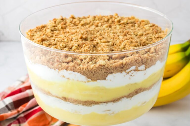 Close up of layered pudding in clear glass trifle bowl.