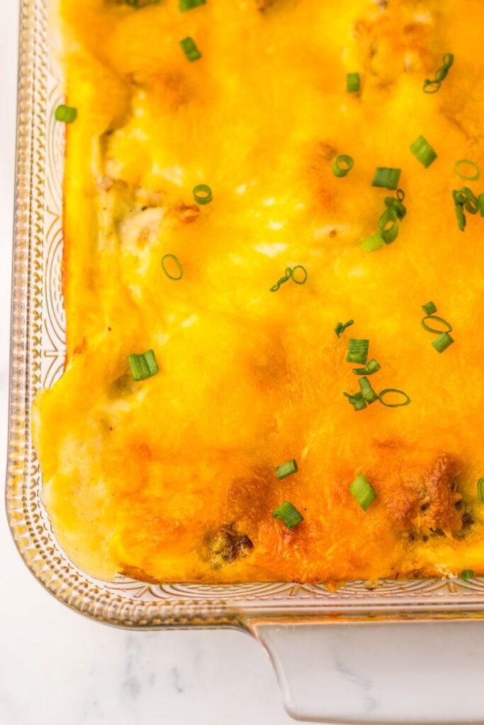 Close up of one corner of cooked casserole topped with melted cheese.