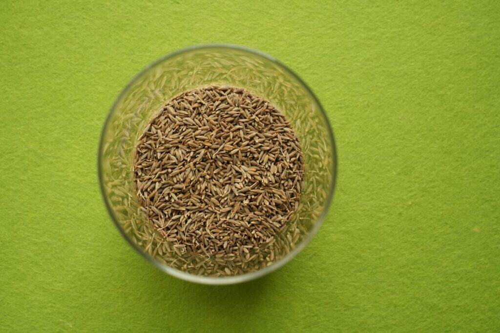 Cumin in clear glass dish.