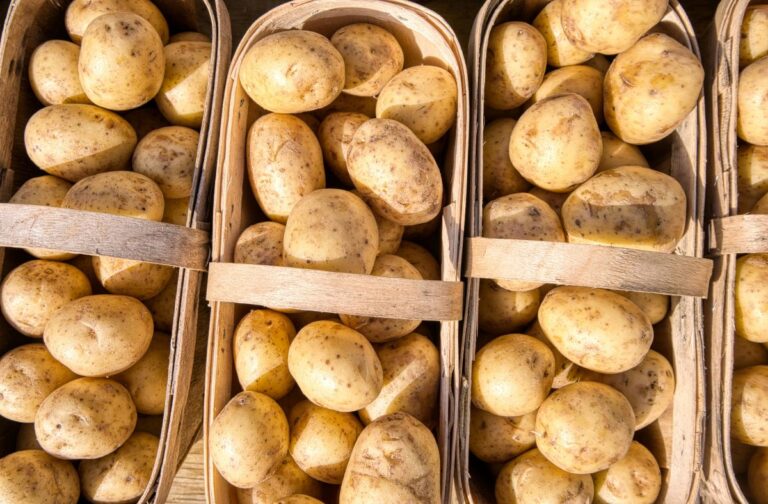 Overhead view of wooden baskets full of potatoes.