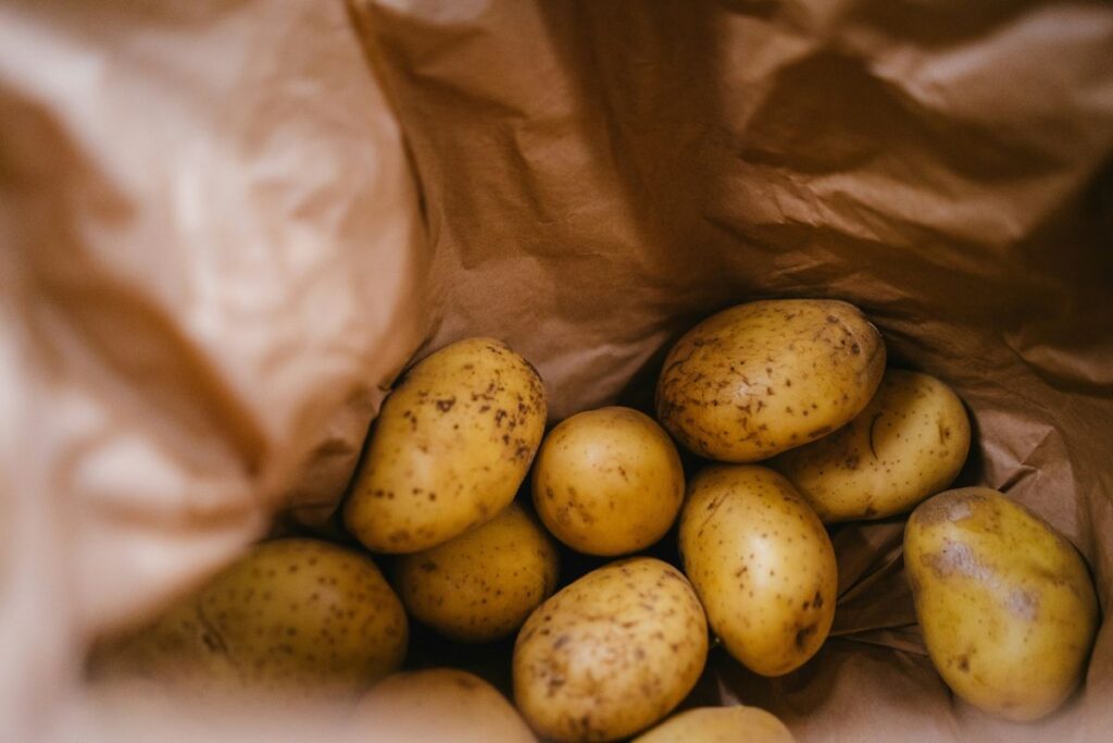 View inside paper bag of whole potatoes.
