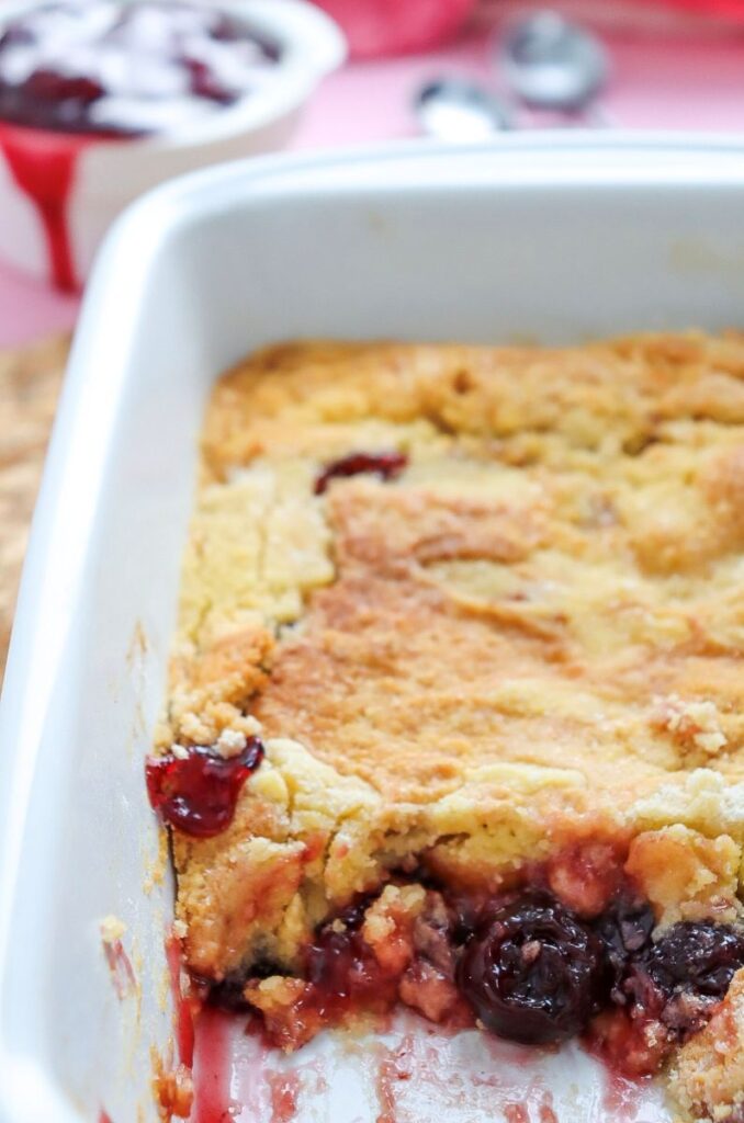 Close up of cherry dump cake with some missing.