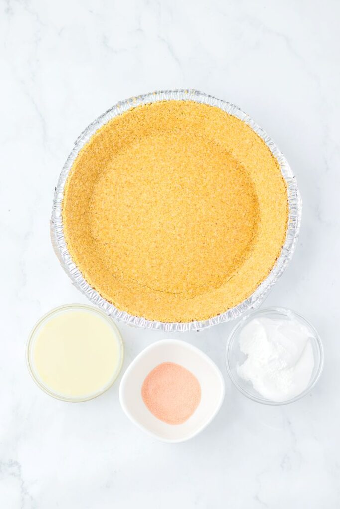 Overhead view of the ingredients for Kool-Aid Pie in small dishes.