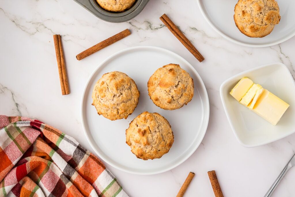 Overhead view of white plate with three muffins.