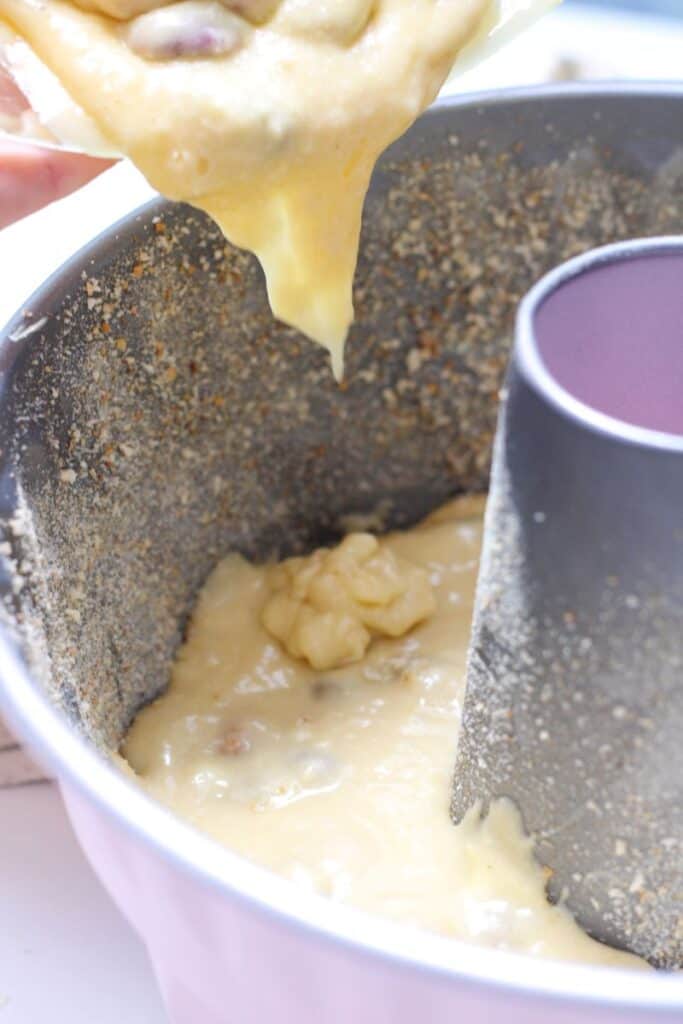 Batter being dropped into bundt pan.