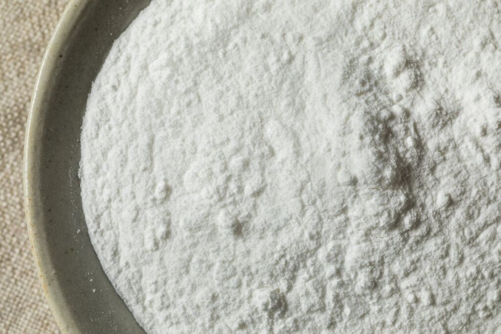 Close up of white powder in gray bowl.