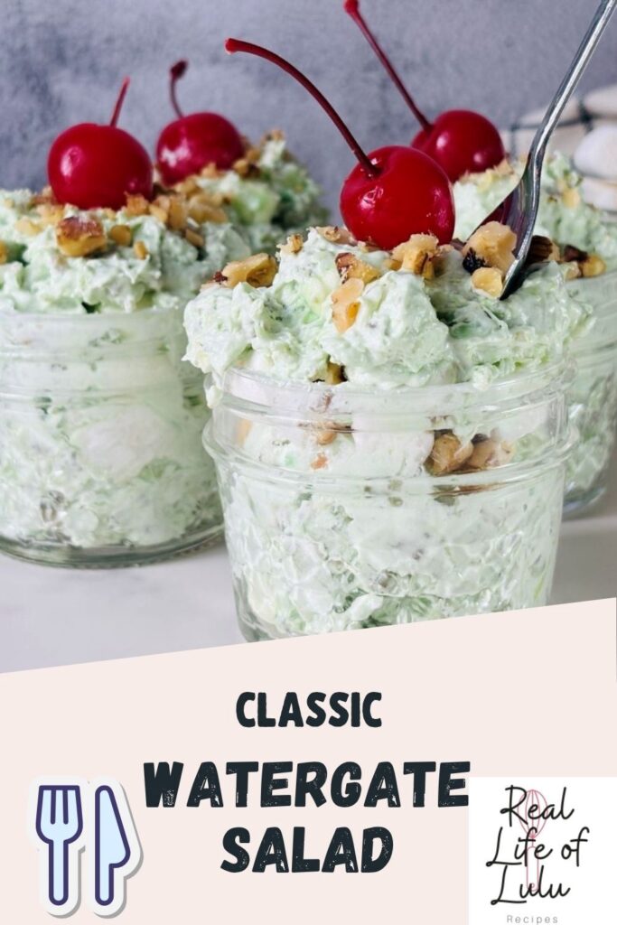 Three glass jars filled with light green Watergate salad, topped with chopped walnuts and maraschino cherries. Spoons are placed in two jars. Text overlay reads Classic Watergate Salad and Real Life of Lulu.