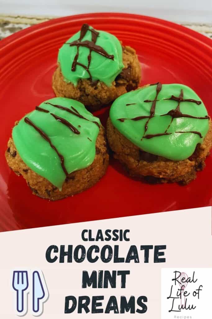 Three chocolate cookies topped with bright green mint frosting and chocolate drizzle are arranged on a red plate. Text reads Classic Chocolate Mint Dreams with a logo for Real Life of Lulu Recipes.
